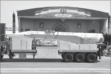  ?? AP/EBRAHIM NOROOZI ?? Iran’s Khoramshah­r missile is displayed by the Revolution­ary Guard on Friday during a military parade marking the 37th anniversar­y of Iraq’s 1980 invasion of Iran in front of the shrine of late revolution­ary founder Ayatollah Khomeini, just outside...