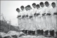  ?? AP ?? Rescuers observe a moment of silence Wednesday for victims recovered from the capsized tourist ship in the Yangtze River in central China’s Hubei province.