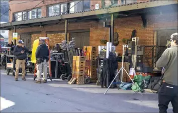  ?? Benjamin B. Braun/Post-Gazette ?? Crew members for season three of “Mayor of Kingstown” work outside Cavo nightclub in the Strip District on Feb. 6. The series created more than 3,000 jobs and injected more than $90 million into the region’s economy, according to the Shapiro administra­tion.