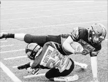  ?? ED TELENKO SPECIAL TO THE ST. CATHARINES STANDARD ?? St. Catharines defender Raydon Gouthro brings down Fort Erie ball carrier Kaden Craft in bantam football Sunday.