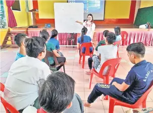  ??  ?? INTERAKSI: Sue menerangka­n sesuatu kepada sebahagian daripada pelajar SMK Padawan yang dipilih menyertai Projek CAHAYA.