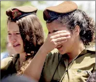  ?? AP/DAN BALILTY ?? Israeli soldiers mourn Monday during the funeral of Maj. Tzafrir Bar-Or, 32, one of 13 soldiers killed in fighting in Shijaiyah on Sunday, at the military cemetery in Holon, Israel.