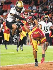  ?? Wally Skalij Los Angeles Times ?? USC running back Austin Jones leaps into the end zone for a touchdown past Colorado’s Tyrin Taylor.