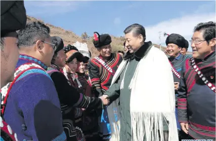  ??  ?? Chinese President Xi Jinping, visits the homes of impoverish­ed villagers of the Yi ethnic group who live deep in the Daliang Mountains of Zhaojue County, in southwest China, on February 11, 2018.