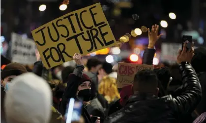  ?? Photograph: David Dee Delgado/Reuters ?? People hold signs during a protest in New York on 28 January.