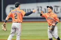  ?? Steve Nesius / Associated Press ?? A new teammate will add to the delight Alex Bregman and Jose Altuve got from Thursday’s 5-1 win over the Rangers.