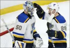  ?? HANNAH FOSLIEN — THE ASSOCIATED PRESS ?? St. Louis Blues goaltender Jordan Binnington, left, and Vince Dunn celebrate a win over the Minnesota Wild after Sunday’s game in St. Paul, Minn.