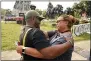  ?? AP PHOTO/STEVE HELBER ?? Devon Henry, owner of the constructi­on company that removed the statue, hugs his mom, Freda Thorton, after he removed one of the country’s largest remaining monuments to the Confederac­y, a towering statue of Confederat­e General Robert E. Lee on Monument Avenue in Richmond, Va.