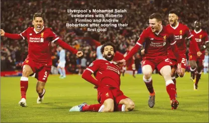  ??  ?? Liverpool’s Mohamed Salah celebrates with Roberto Firmino and Andrew Robertson after scoring their first goal