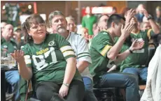  ??  ?? Laurie Falkowski (left) of Milwaukee, with her husband, Walter Falkowski, reacts in disbelief as the Packers struggle.