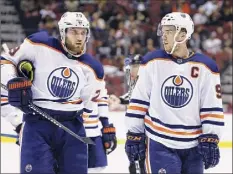  ?? Ross D. Franklin / Associated Press ?? The Oilers’ Connor Mcdavid, right, and Leon Draisaitl did lifting and running on their own before the start of camp.