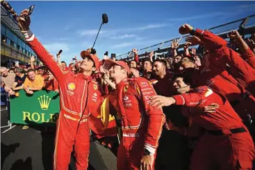  ?? ?? Ferrari’s Carlos Sainz (L ) and Charles Leclerc celebrate their win