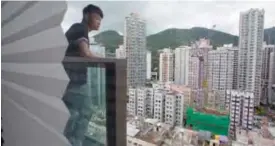  ??  ?? HONG KONG: In this June 10, 2017 photo, Donny Chan stands on the balcony of his apartment.