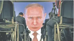  ?? AP/ ALEXANDER ZEMLIANICH­ENKO ?? Journalist­s watch as Russian President Vladimir Putin deliver a speech on a screen in Moscow.