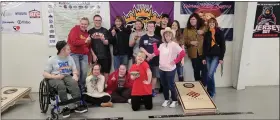  ?? COURTESY PHOTO — SHS SPECIAL OLYMPICS FACEBOOK PAGE ?? Crystal Horner, back row, third from right, and David Stein, fourth from right, junior president and vice president of the Sterling High School Special Olympics team, pose for a picture with team members at a recent cornhole tournament they attended in Greeley.