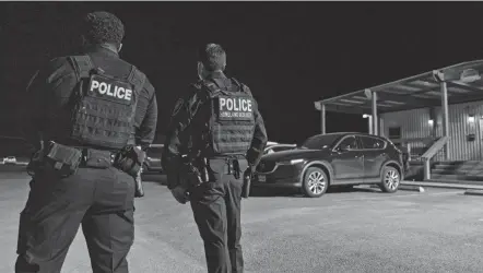  ?? ELI HARTMAN/ODESSA AMERICAN VIA AP FILE ?? Department of Homeland Security officers wait for the arrival of migrant children and teenagers March 14 at a temporary holding facility in Midland, Texas.