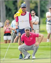  ?? AP PHOTO ?? Webb Simpson, bottom, lines up a putt on the seventh green with caddie Paul Tesori during the final round of The Players Championsh­ip golf tournament Sunday in Ponte Vedra Beach, Fla.