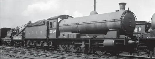  ?? A N H Glover/Kiddermins­ter Railway Museum ?? A view by F A Wycherley records Raven ‘Q6’ (NER ‘T1’) class 0-8-0 No 2254 in the yard outside Carlisle Canal shed on Tuesday, 10 August 1937. A small travelling crane with a match truck is on the left, and a clerestory roofed coach is seen beyond the locomotive and to the right. Facing the shed exit, although not in steam it does appear that the locomotive is in service, so by implicatio­n Canal shed was an operationa­l base for what was still on paper a London Road-allocated engine. Without doubt, despite being on an ex-North British Railway shed, the bread and butter work for this locomotive would remain the Newcastle & Carlisle line until its transfer away to West Hartlepool on 29 March 1939. This engine proved long-lived, its career ending at Tyne Dock on 26 April 1965.