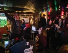  ?? JOE BUGLEWICZ/NEW YORK TIMES ?? Cramped and smoky, Santa’s Pub is a favourite Nashville dive bar, with cold, cheap beer and live music.