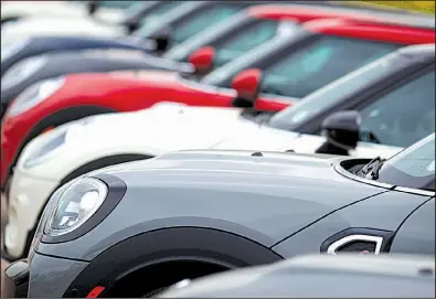  ?? AP ?? American spending in April. on such things as new vehicles like these Cooper Countryman models at a dealership in Colorado, revved up