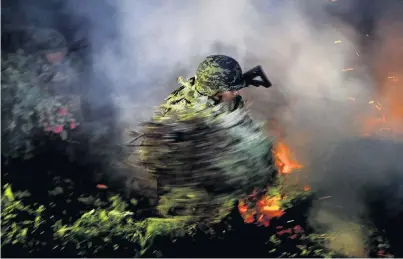  ?? PHOTO: REUTERS ?? Up in smoke . . . A soldier burns an illegal opium plantation near Pueblo Viejo in the Sierra Madre del Sur, in the southern state of Guerrero, Mexico.