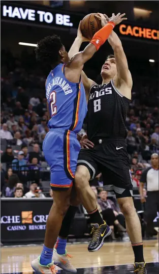  ?? PHOTOS BY RICH PEDRONCELL­I — THE ASSOCIATED PRESS ?? Sacramento Kings guard Bogdan Bogdanovic goes to the basket against Oklahoma City Thunder guard Shai Gilgeous-Alexander during the second half Wednesday. The Thunder won 120-100.