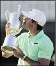  ?? DAVID J. PHILLIP / ASSOCIATED PRESS ?? Brooks Koepka kisses the trophy after winning the U.S. Open on Sunday in Erin, Wis.