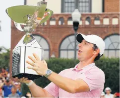  ??  ?? Silver lining: Rory McIlroy celebrates with the FedEx Cup in Atlanta after victory in the Tour Championsh­ip