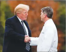  ?? CAROLYN KASTER / AP ?? President Donald Trump shakes hands with White House physician
Dr. Ronny Jackson in January. Amid a flurry of controvers­y, Jackson’s nomination to head the Department of Veterans Affairs ended with his withdrawal. In only 15 months in office, Trump...