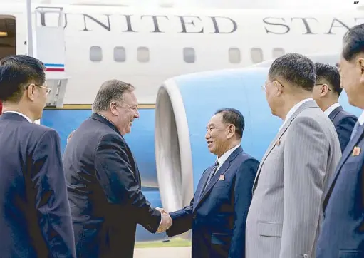  ?? AP ?? United States Secretary of State Mike Pompeo is greeted by North Korean Director of the United Front Department Kim Yong-chol as he arrives at Sunan Internatio­nal Airport in Pyongyang on Friday.