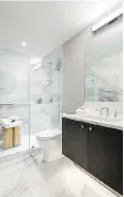  ??  ?? Ensuite bathrooms feature floorto-ceiling tiled walls and frameless glass showers and/or soaker tubs.