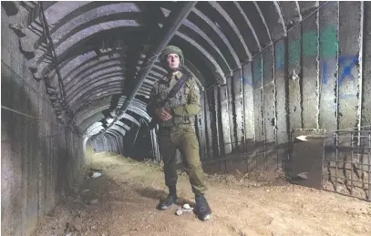  ?? (Amir Cohen/Reuters) ?? THE FIRST IDF spokespers­on in recent decades to speak to the internatio­nal media regularly, Brig.-Gen. Daniel Hagari stands in an iron-girded tunnel designed by Hamas.