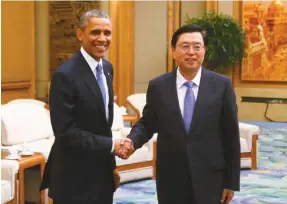  ??  ?? .S. President Barack Obama, left, shakes hands with Chairman of the Standing Committee of the National People’s Congress (NPC) Zhang Dejiang during a meeting at the Great Hall of the People in Beijing Wednesday, Nov. 12, 2014. (AP Photo/Petar...