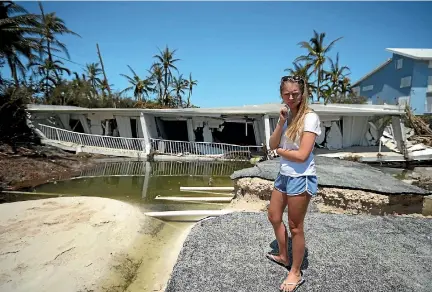  ?? PHOTOS: REUTERS ?? A resident reacts as she sees the damage to her home from Hurricane Irma on Islamorada Key in the Florida Keys.