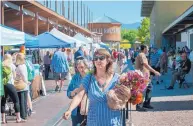  ?? EDDIE MOORE/JOURNAL ?? Nellie Tischler, of Santa Fe, shops at the Santa Fe Farmers’ Market in the Railyard earlier this week. Events at the Railyard this weekend will celebrate its 10th anniversar­y. The farmers’ market is celebratin­g its own 50th anniversar­y.