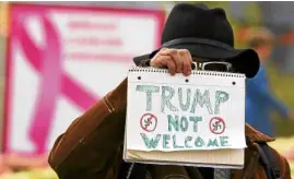  ?? —AP ?? STRONG FEELINGS APennsylva­nian holds a sign to protest the arrival of President Donald Trump in Pittsburgh on Oct. 30.