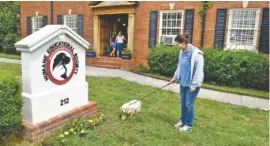  ?? STAFF FILE PHOTO ?? Humane Educationa­l Society of Hamilton County staff member Danielle Austin walks a dog in the society’s front yard.