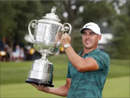  ?? JEFF ROBERSON — THE ASSOCIATED PRESS ?? Brooks Koepka holds the Wanamaker Trophy after winning the PGA Championsh­ip at Bellerive Country Club, Sunday in St. Louis.