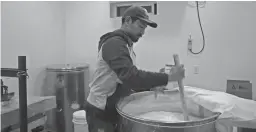  ?? COURTESY OF ATSUO SAKURAI ?? Atsuo Sakurai stirs a batch of Arizona Sake that he brews in Holbrook. Each batch takes three months to complete.