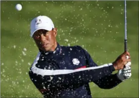  ?? FRANCOIS MORI — THE ASSOCIATED PRESS ?? Tiger Woods plays from a bunker on the third hole during a practice session at Le Golf National in Guyancourt, outside Paris, France, on Sept. 25.