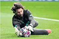  ??  ?? Liverpool’s Alisson Becker warms up before the Champions League match against Atletico in Madrid.