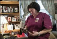  ?? MARK LENNIHAN — THE ASSOCIATED PRESS ?? In this photo, Rose Cobo holds a framed photo of her daughter, Chelsea, at her house in the Brooklyn borough New York. Chelsea disappeare­d in May of 2016. of