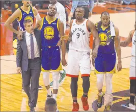  ?? Chris Young The Associated Press ?? Warriors forward Kevin Durant (35) walks off the court after sustaining a ruptured right Achilles tendon during Game 5 of the NBA Finals on Monday in Toronto. He is expected to leave Golden State this offseason after winning two titles.