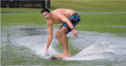  ?? Picture / NZME ?? Some residents made the most of flooding on Tauranga’s Penberton Park after the heavy rain.