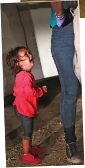  ??  ?? Heartbreak: A girl of two cries as her mother is detained at the border