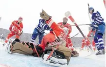  ?? Dave Reginek/NHL via Getty Images ?? Detroit Red Wings goalie Jimmy Howard makes a spinning arm save as the Leafs’ David Clarkson, left, and Nazem Kadri look on.