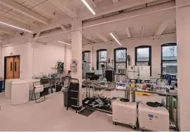  ?? Vincent Gabrielle/Hearst Connecticu­t Media ?? The large test reactor in the lab space of Protein Evolution, a New Haven plastics recycling startup, is seen wrapped in black against the windows. The test reactor digests PET plastic into its component monomers.