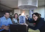  ?? ?? Anna Salton Eisen holds up a photo of Emil Ringel, father of Barbara Ringel, for a Zoom video call during a gathering for families of Holocaust survivors in East Brunswick, N.J., on Sunday.