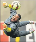  ?? Picture: GALLO IMAGES ?? FLYING LEAP: Goalkeeper Itumeleng Khune in action during Bafana’s training session at the Cape Town Stadium yesterday