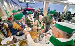  ?? —PTI ?? Farmers representa­tives have food during a break at Vigyan Bhawan, amid the seventh round of talks between the farmer leaders and the Central government, in New Delhi on Monday.